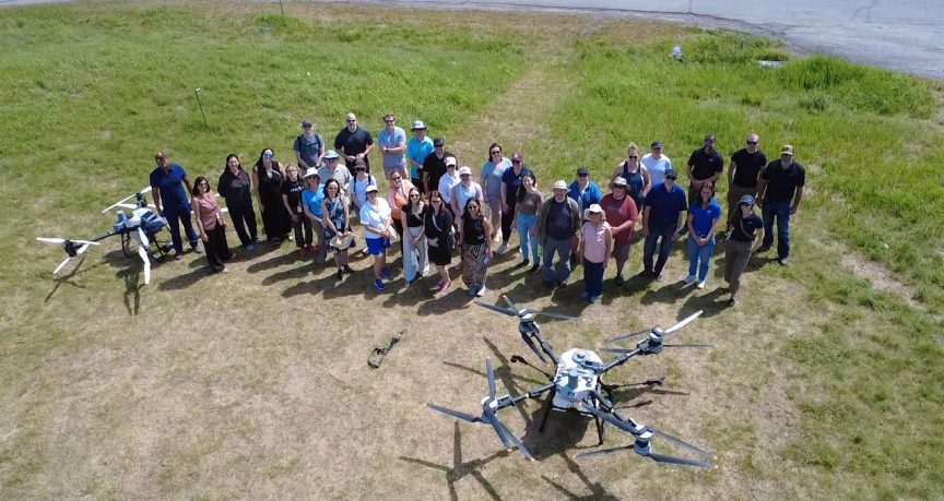 Participants at the Area X.O meeting with Health Canada PRD gather around a drone.